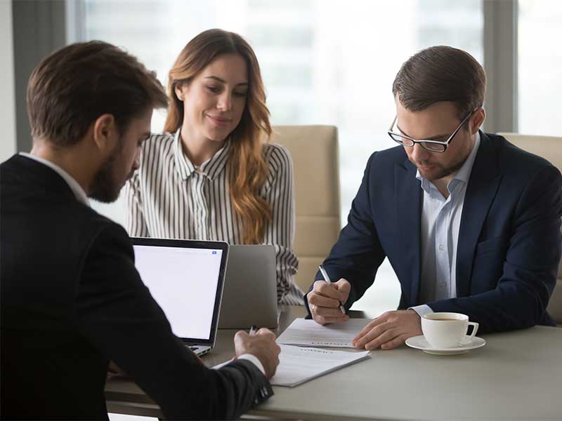 Business people meeting and a man in a suit signing paper